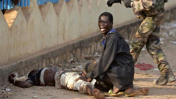 A-man-reacts-next-to-a-demonstrator-who-was-shot-near-the-international-airport-in-Bangui-AFP