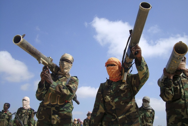 Members of the hardline al Shabaab Islamist rebel group hold their weapons in Somalia's capital Mogadishu