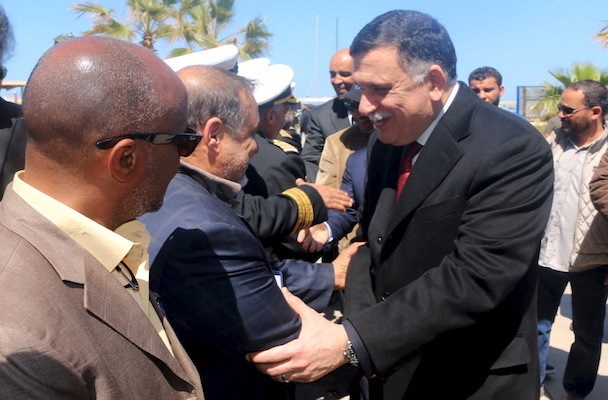 Libyan Prime Minister-designate Fayez Seraj (R) is greeted upon arrival in Tripoli, Libya March 30, 2016. REUTERS/Hani Amara - RTSCV7R