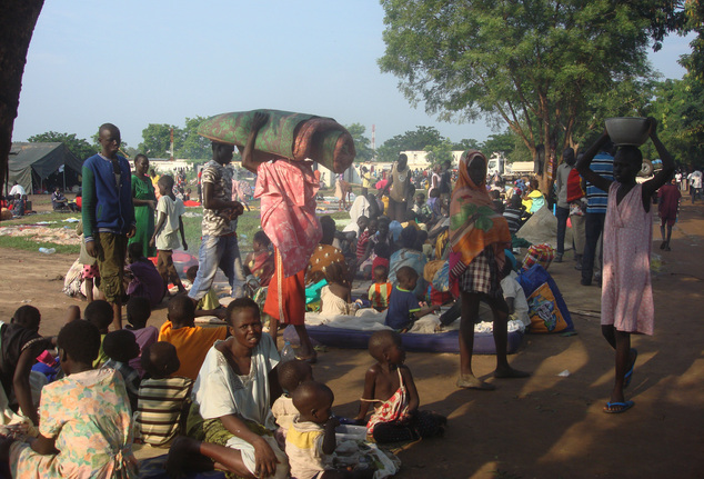 At least 3000 displaced women, men and children gather to seek shelter in Juba, South Sudan at the UN compound in Tomping area, Monday, July 11, 2016. Heavy explosions are shaking South Sudan's capital Juba Monday morning as clashes between government and opposition forces entered their fifth day, witnesses say, pushing the country back toward civil war. (Beatrice Mategwa/UNMISS via AP)