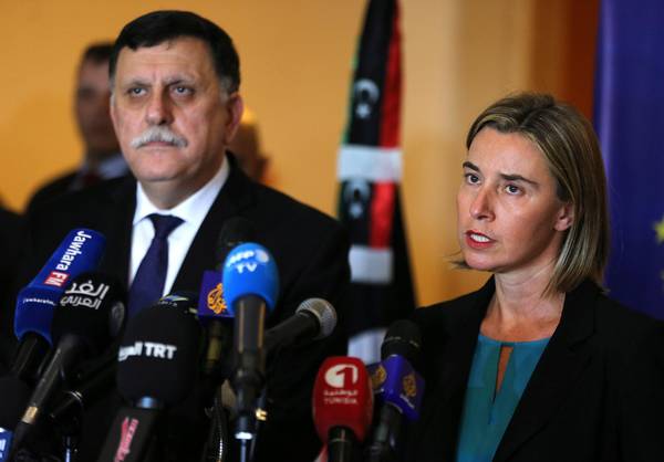 epa05092861 High Representative of the European Union for Foreign Affairs and Security Policy Federica Mogherini (R) speaks during a press conference with Libyan Prime Minister Fayez Sarraj (L) after their meeting in Tunis, Tunisia, 08 January 2016. Mogherini is meeting in Tunis with Sarraj and members of the Libyan Presidency Council to discuss ways to support Libya after signing a peace agreement among warring factions in the country. EPA/MOHAMED MESSARA