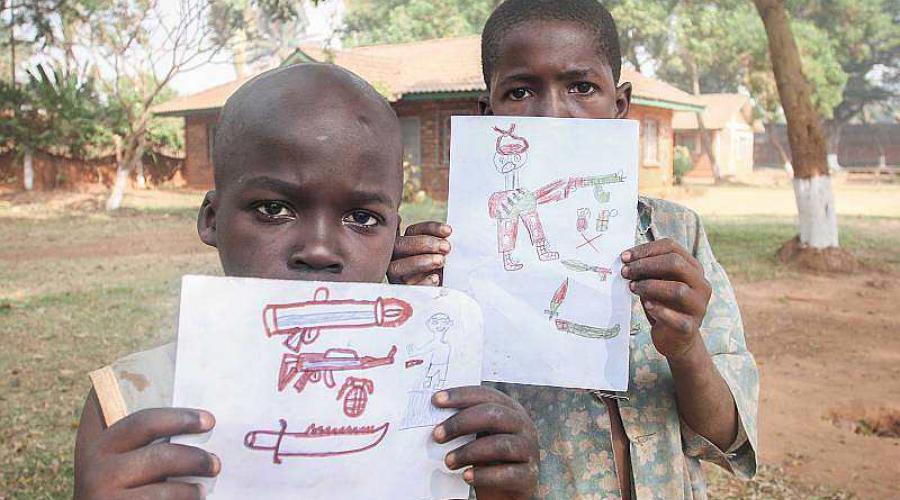 Bambini mostrano disegni di armi