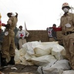 Red Cross workers collect bodies in body bags to load onto a truck in Ndosho near Goma