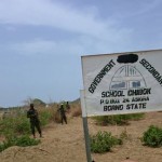 Soldiers stand guard in front of the school in Chibok, Nigeria