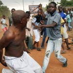 A Christian man chases a suspected Seleka officer in civilian clothes with