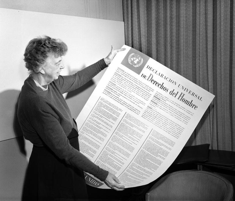 Mrs. Eleanor Roosevelt of the United States holding a Declaration of Human Rights poster in Spanish. November 1949.