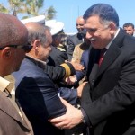 Libyan Prime Minister-designate Fayez Seraj is greeted upon arrival in Tripoli