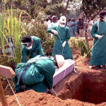 Red Cross workers burry 14 May Italian nun Dinaros