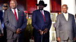 Leader of the Sudan People’s Liberation Movement In Opposition (SPLM-IO) Riek Machar stands next to South Sudan’s President Salva Kiir and Uganda’s President Yoweri Museveni after a tripartite summit at the State House in Entebbe
