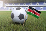 Kenyan flag in stadium field with soccer football